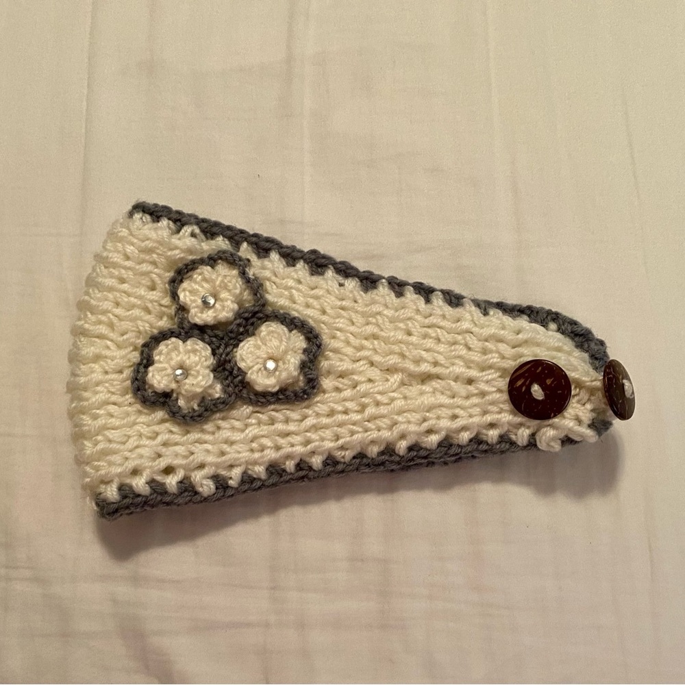 Cold weather cream and gray head band with flower accent.